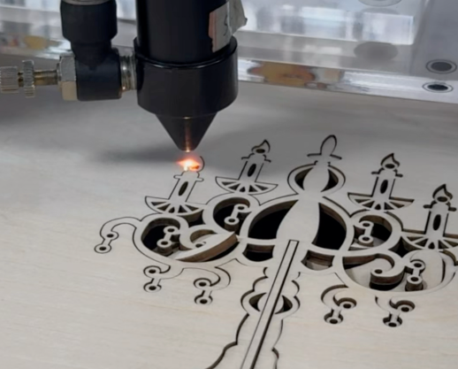 Laser cutting machine engraving intricate patterns on a wooden board