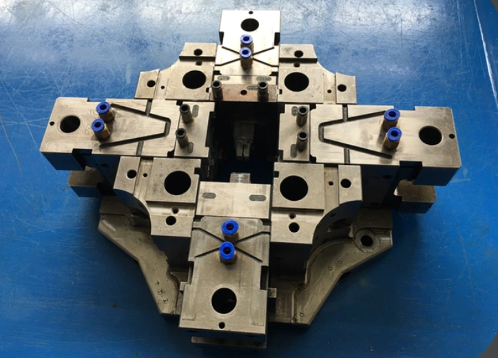 Precision die casting mold and polished tool steel cavity insert on a granite surface plate