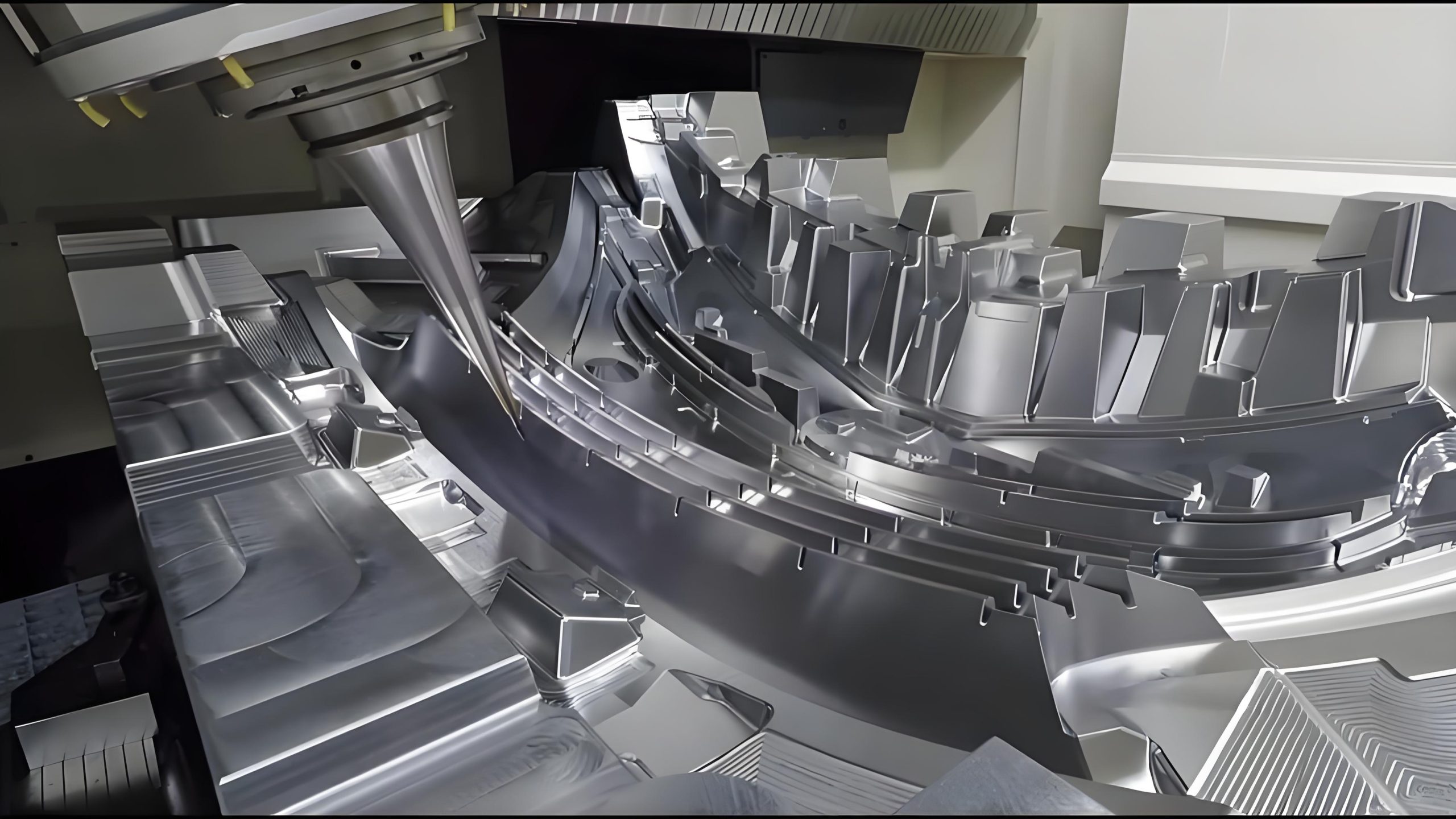 CNC milling machine cutting a steel mold insert