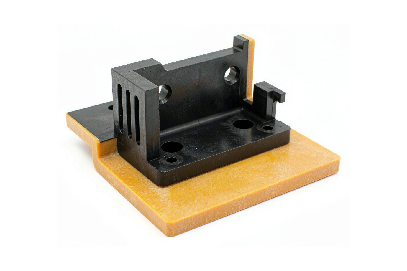 CNC machined ABS bracket with clean milled edges and drilled holes on a white background