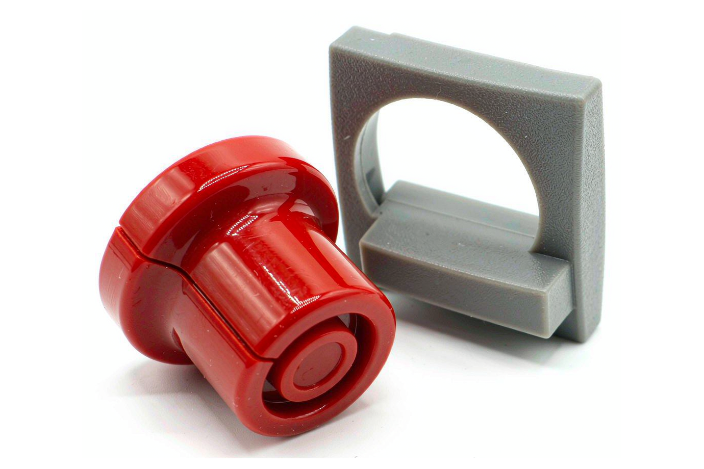 Glossy red painted ABS knob beside a matte textured ABS panel showing cosmetic finish options
