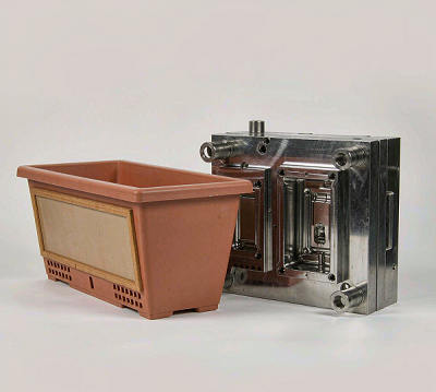 Finished bonsai planter shown next to its injection mold
