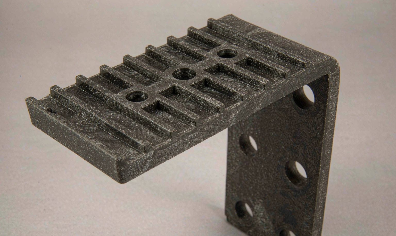 Glass-filled nylon structural bracket with thick ribbed walls