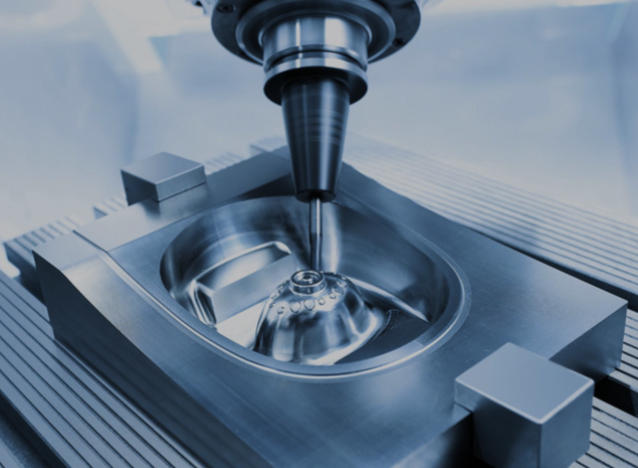 CNC vertical machining center milling an aluminum die cast part with cutting fluid