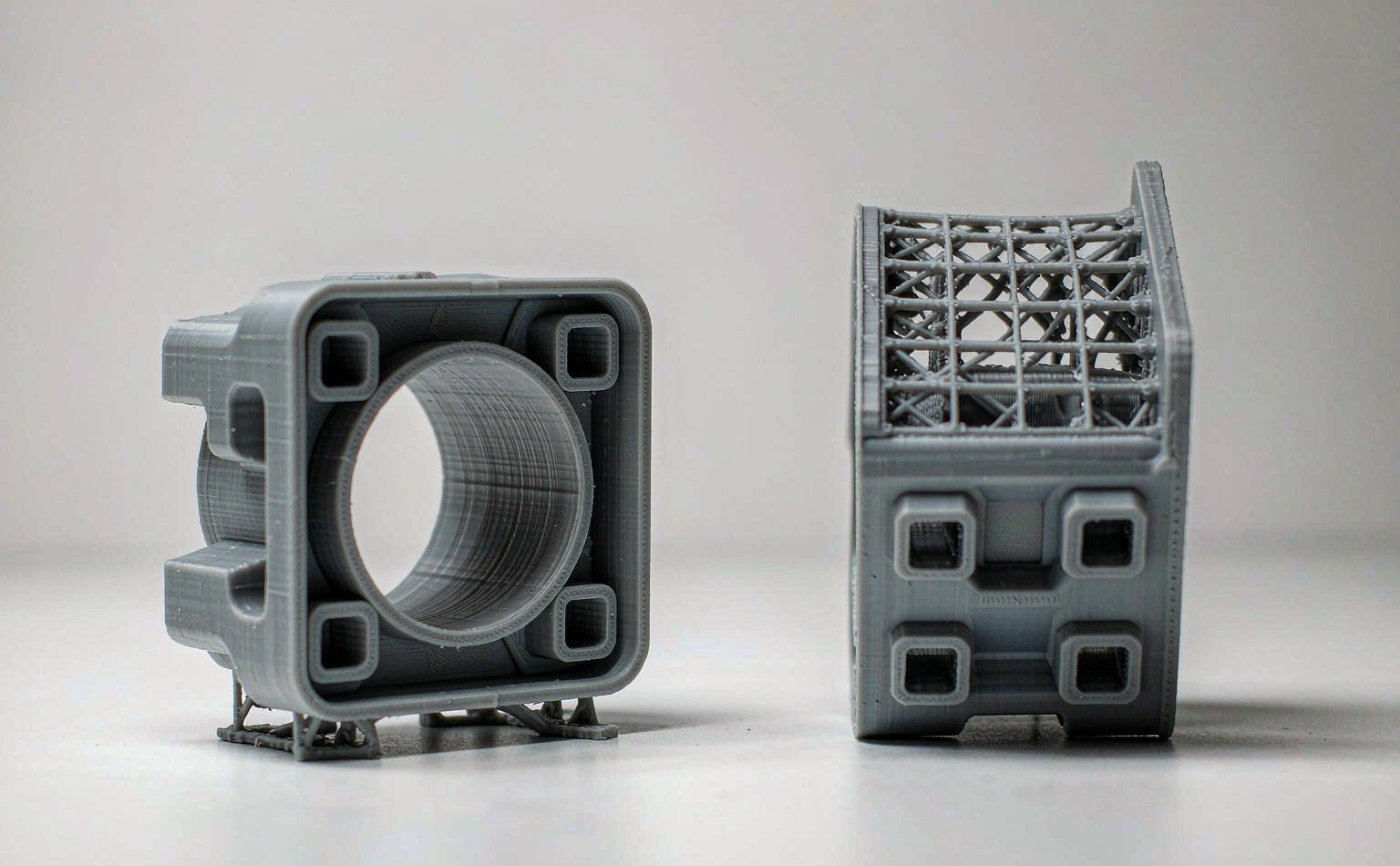 The same mechanical bracket printed flat and vertically to show how orientation changes support needs