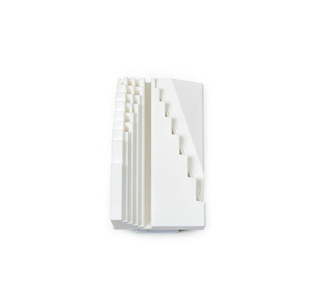 3D printed wall-thickness and overhang test specimen showing progressively thinner walls and stepped angles