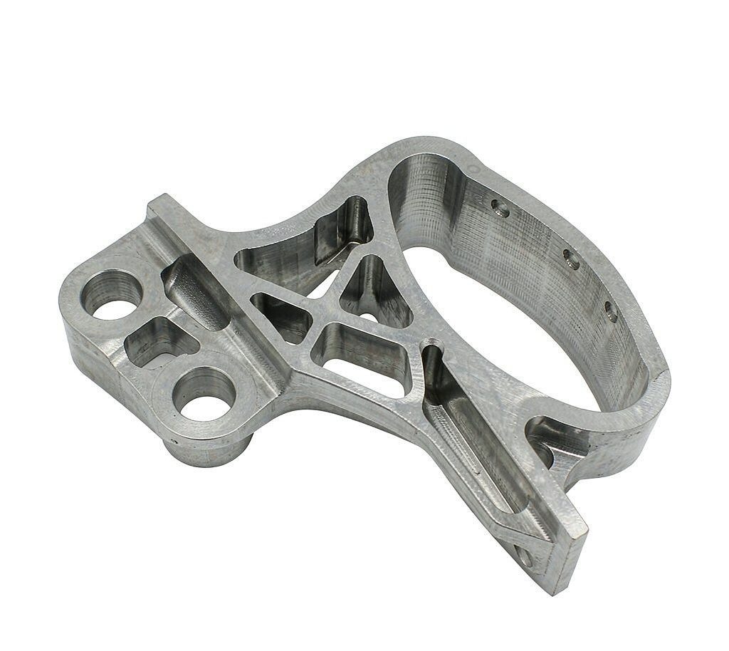 Close-up of a CNC machined aluminum e-bike motor mounting bracket with bored holes and pockets