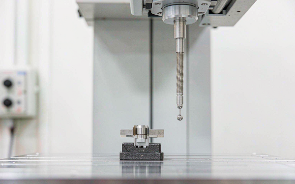 CMM measuring a titanium medical component in a precision vice