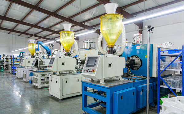Injection moulding workshop with a row of moulding machines at the Xiamen Goldcattle factory in China