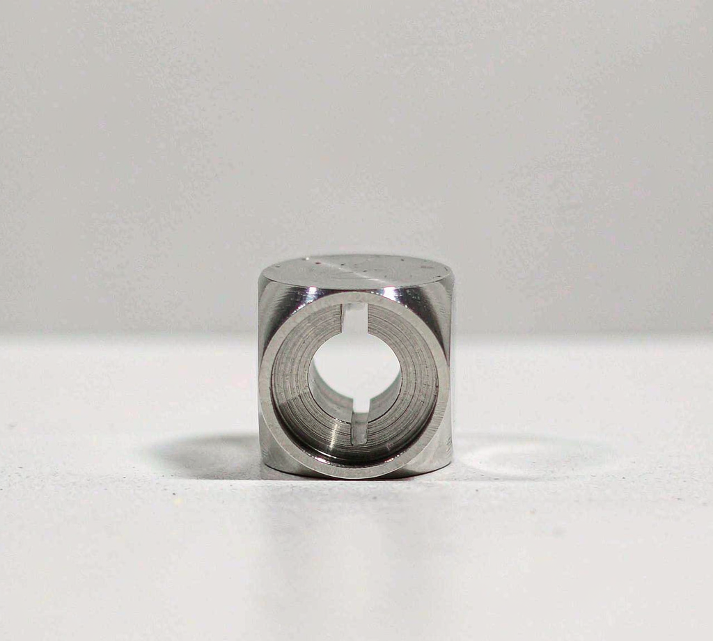 CNC machined medical component, single small titanium part on a clean bench