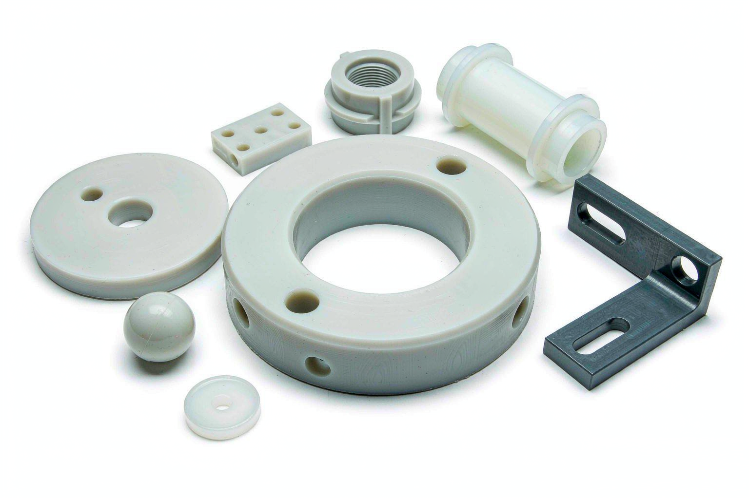 Assorted precision CNC machined engineering plastic components including PEEK, POM and nylon parts