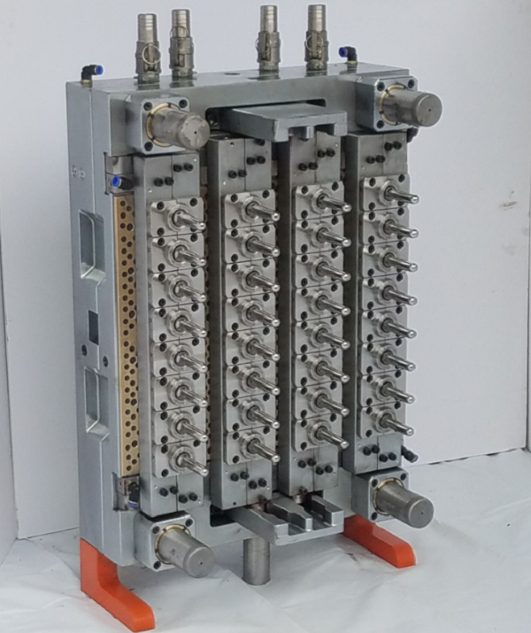 Multi-cavity injection mold with hot runner manifold and polished steel cavities
