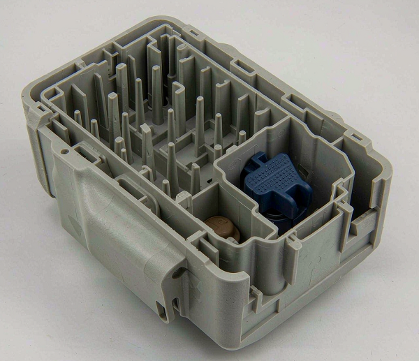 Grey engineering plastic injection molded equipment housing with ribs, bosses and snap-fit features on a white background