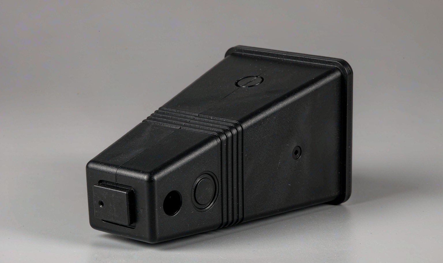 Injection molded housing with a side undercut released by a slide core