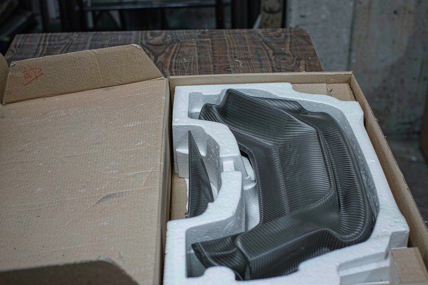 Custom automotive spoiler parts foam-packed in a shipping carton