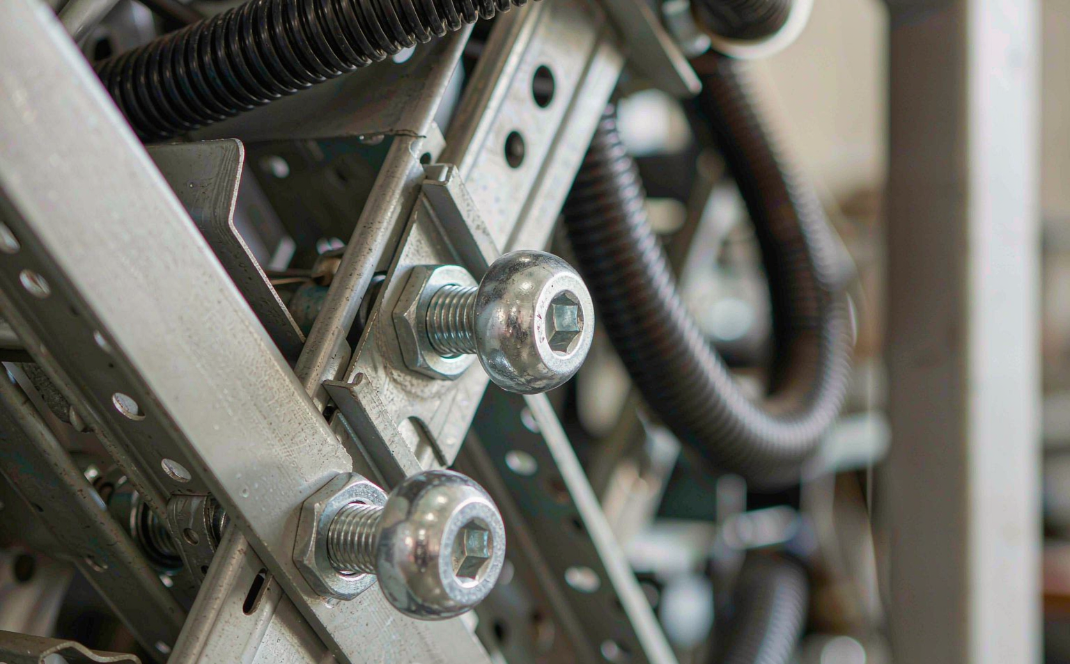 Stainless steel hex socket screws installed fastening a section of industrial machinery and automation equipment