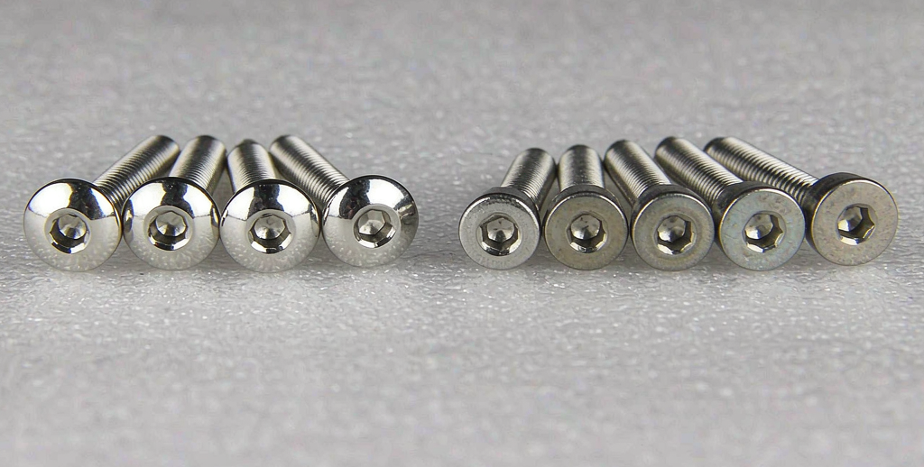 Two batches of stainless steel hex socket screws showing a brighter polished finish and a matte passivated finish