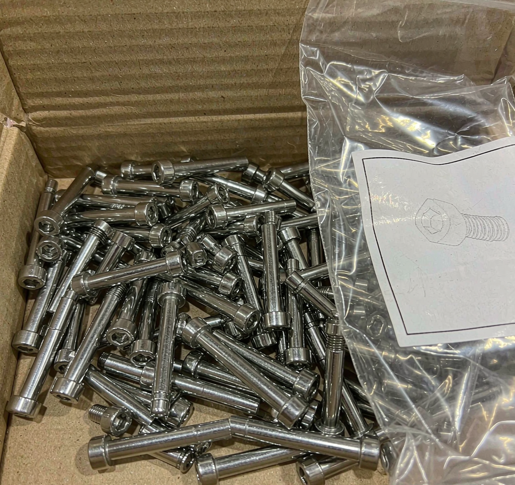 Stainless steel hex socket screws packed in a corrugated box and a sealed bag with a blank label area