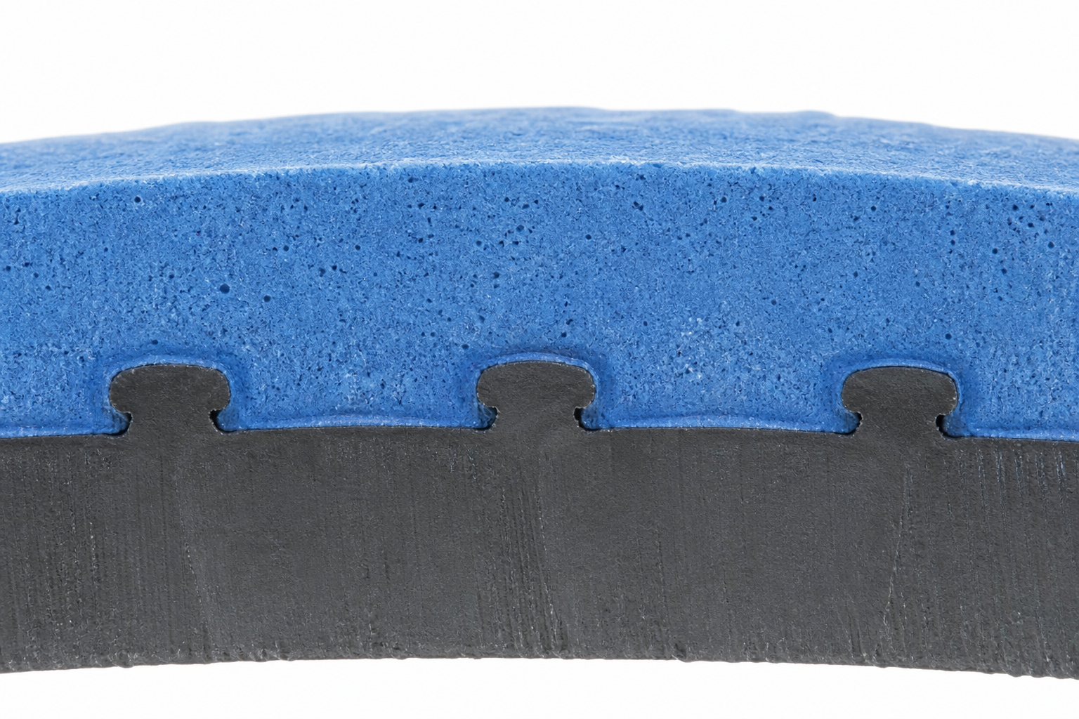 Cross-section of overmolded part showing chemical bond between rigid ABS substrate and TPE elastomer layer