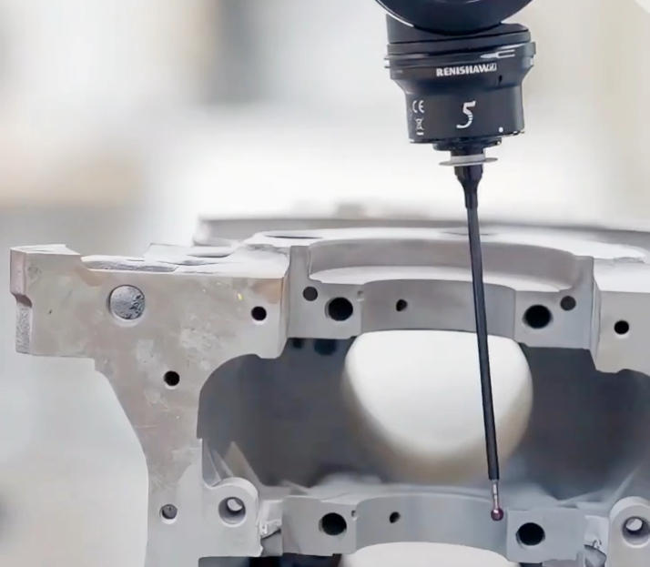 CMM probe measuring a titanium machined part during inspection
