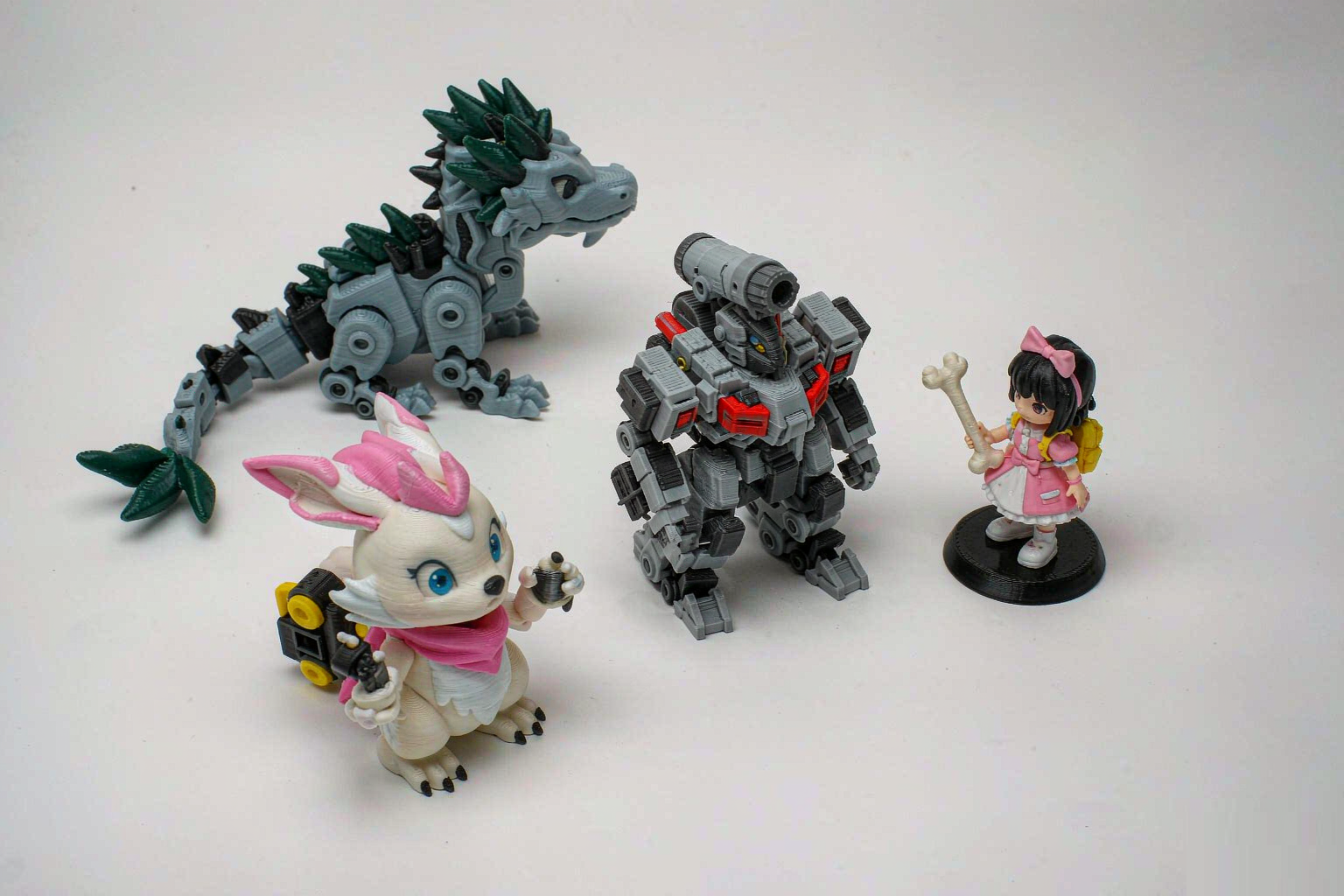 A collection of custom 3D printed toy figures and figurines on a white background