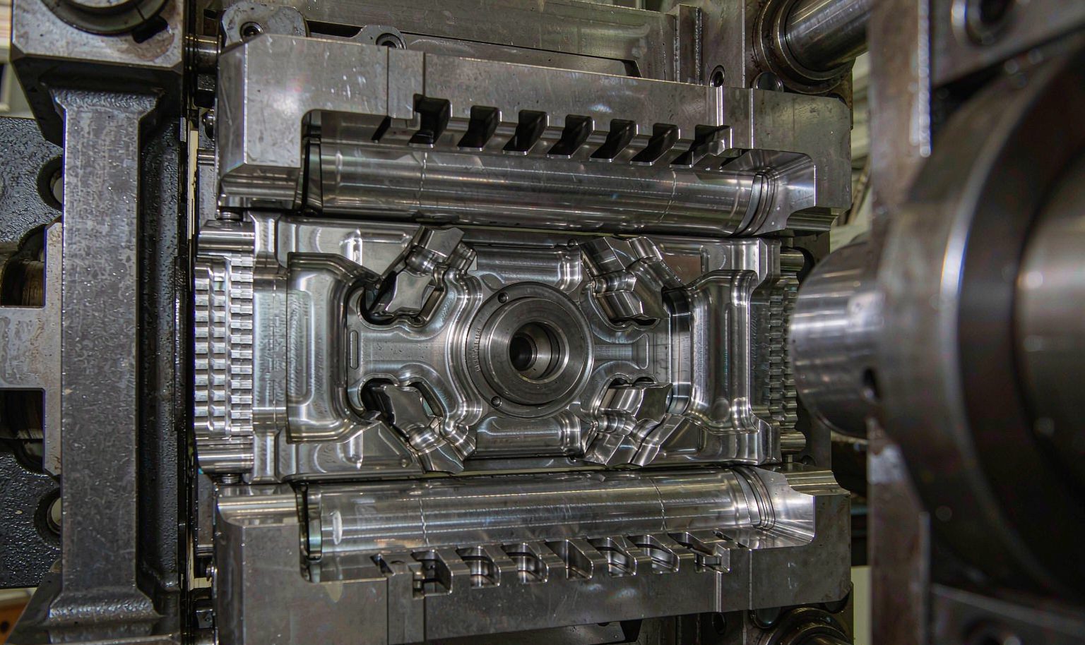 Steel two-shot injection mold with precision cavities installed in a molding machine