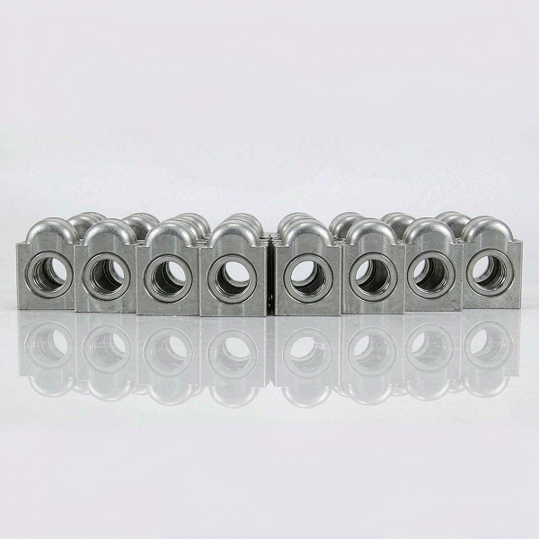 Row of identical machined aluminium parts on a white inspection bench