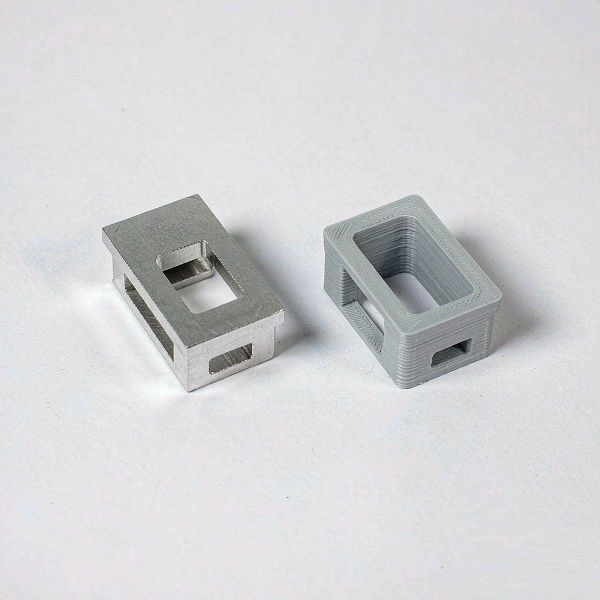 Side-by-side comparison of a CNC machined aluminium part and a 3D printed part with visible layer lines