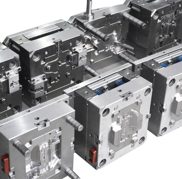 Open injection mould showing polished steel cavity and core halves with ejector pins