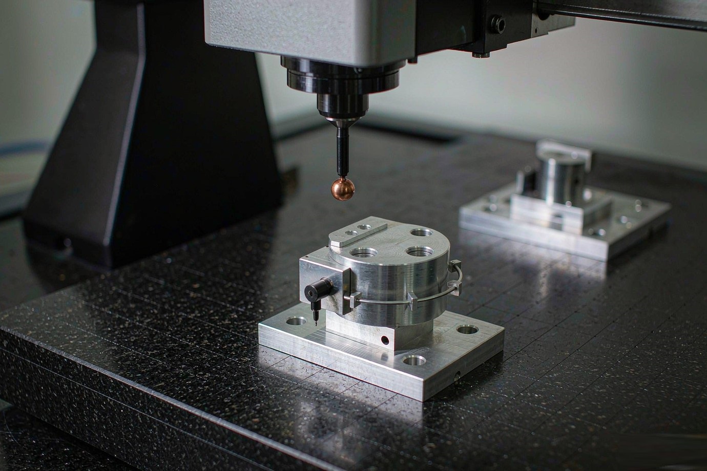 Illustrative — CMM inspecting a machined aluminum part