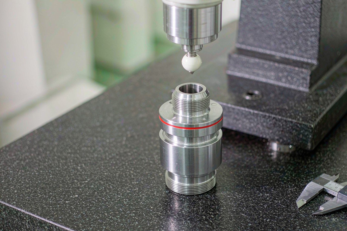 Inspection of a machined driveline component with measuring tools on a granite plate