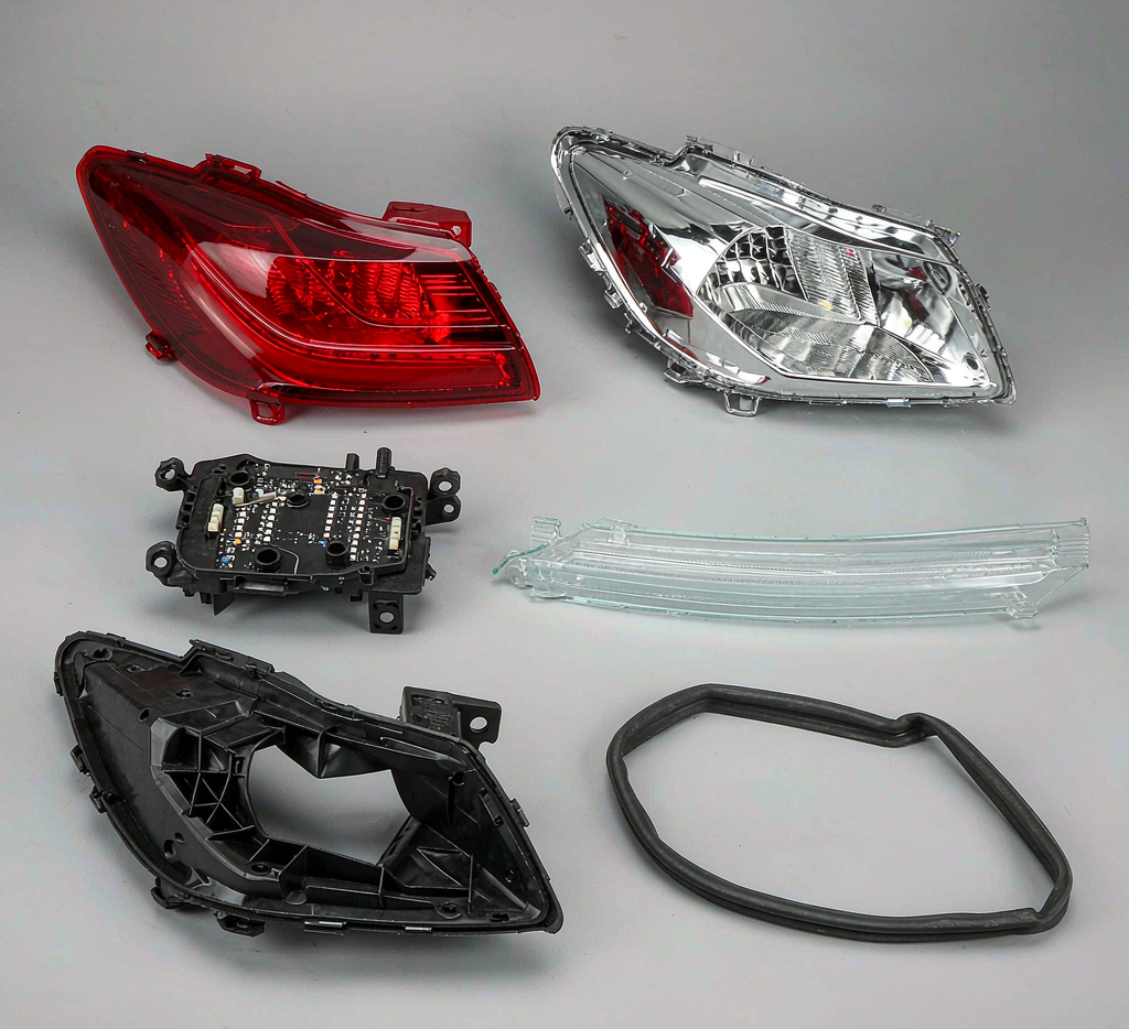 Separated automotive tail light components: lens, reflector, LED board, light guide, housing, gasket