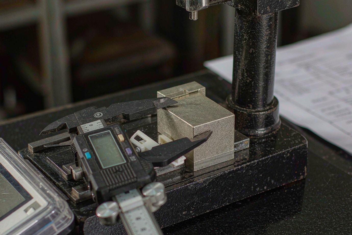 Inspection of a fabricated fuel-tank component with calipers on a granite plate