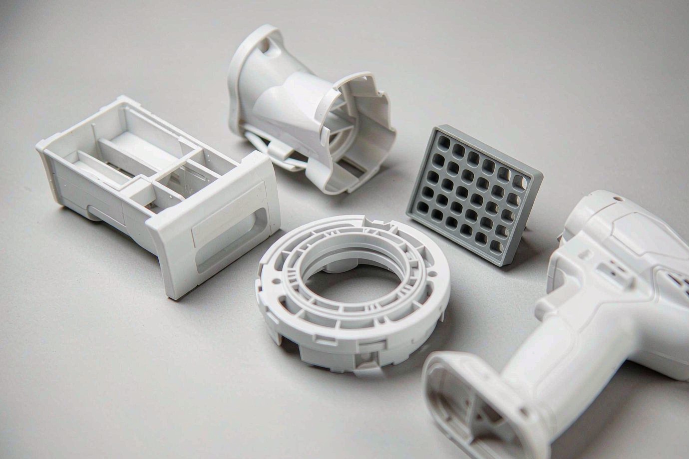 Illustrative collection of injection-molded white home appliance plastic components