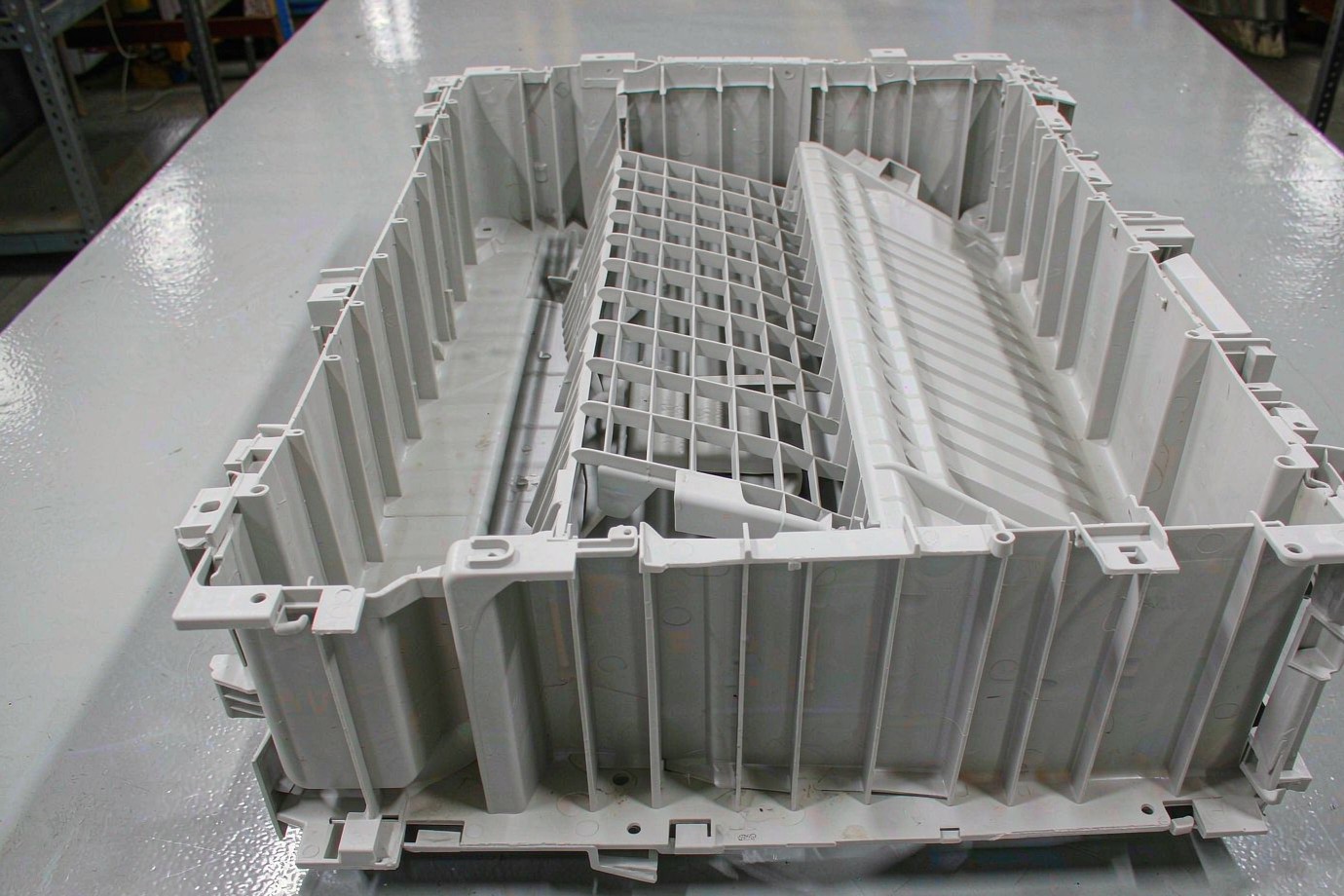 Illustrative ribbed injection-molded appliance housing with mounting bosses and snap features