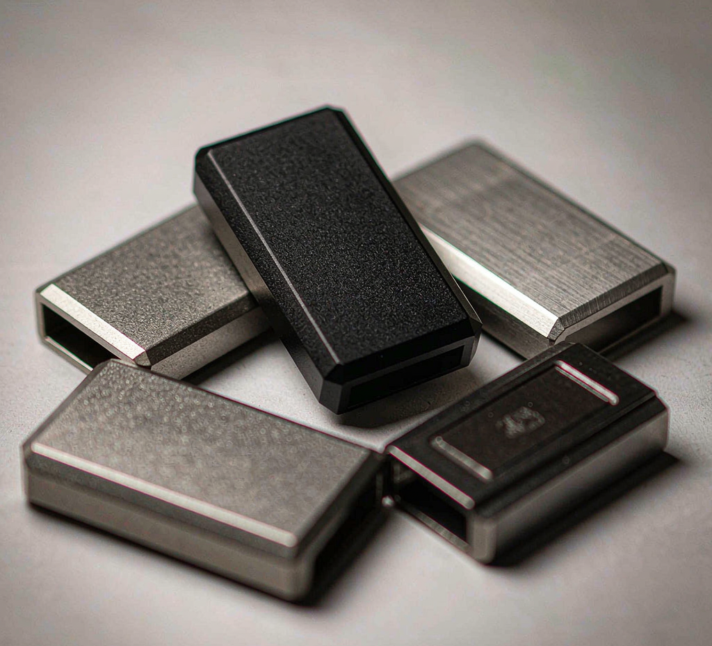 CNC-machined metal car key fob cases in aluminum and stainless steel finishes