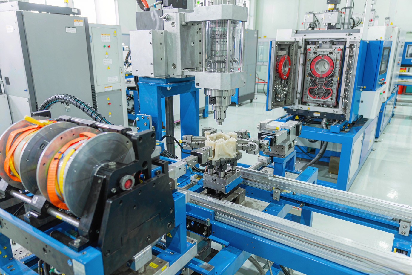 Illustrative — modern LSR liquid silicone injection molding machine in a bright clean production cell
