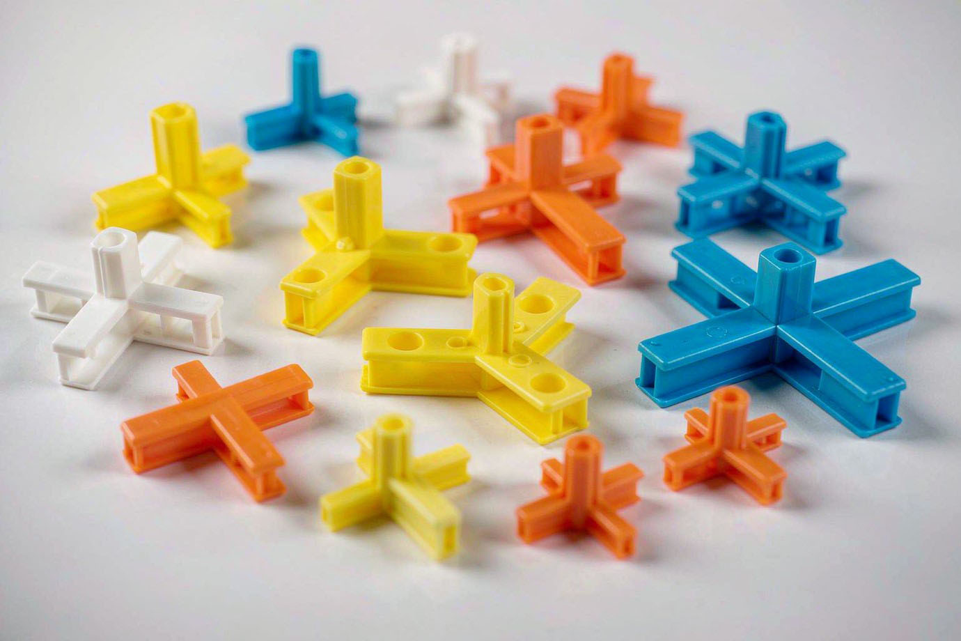 Illustrative — assortment of plastic tile spacers in cross, T and Y shapes and several joint widths