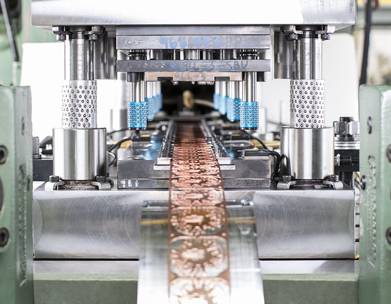 Progressive die stamping process in action