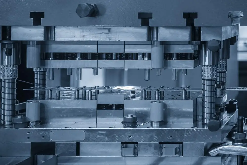 Progressive die stamping press operation in manufacturing workshop