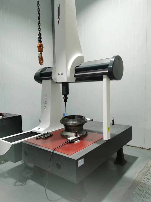 Mitutoyo CMM machine inspecting a precision machined part