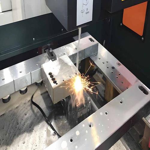 Wire EDM machine cutting intricate shapes in hardened steel tooling