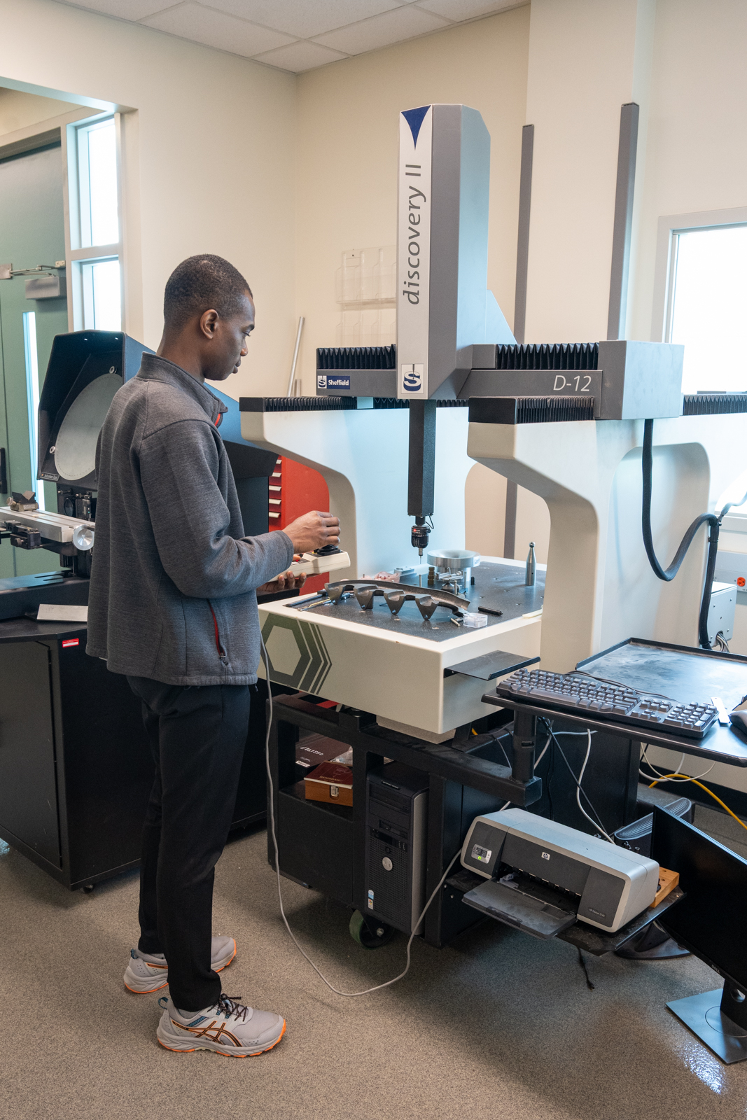 Engineer performing CMM inspection on precision mold parts
