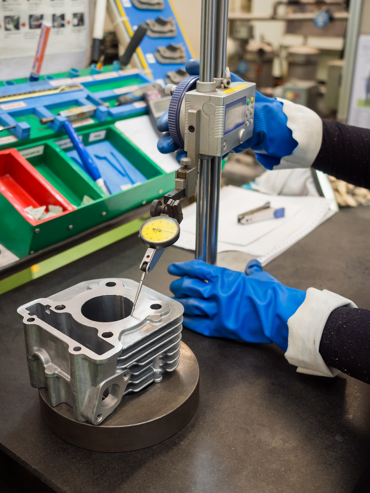 Operator Inspecting Automotive CNC Parts with Height Gauge