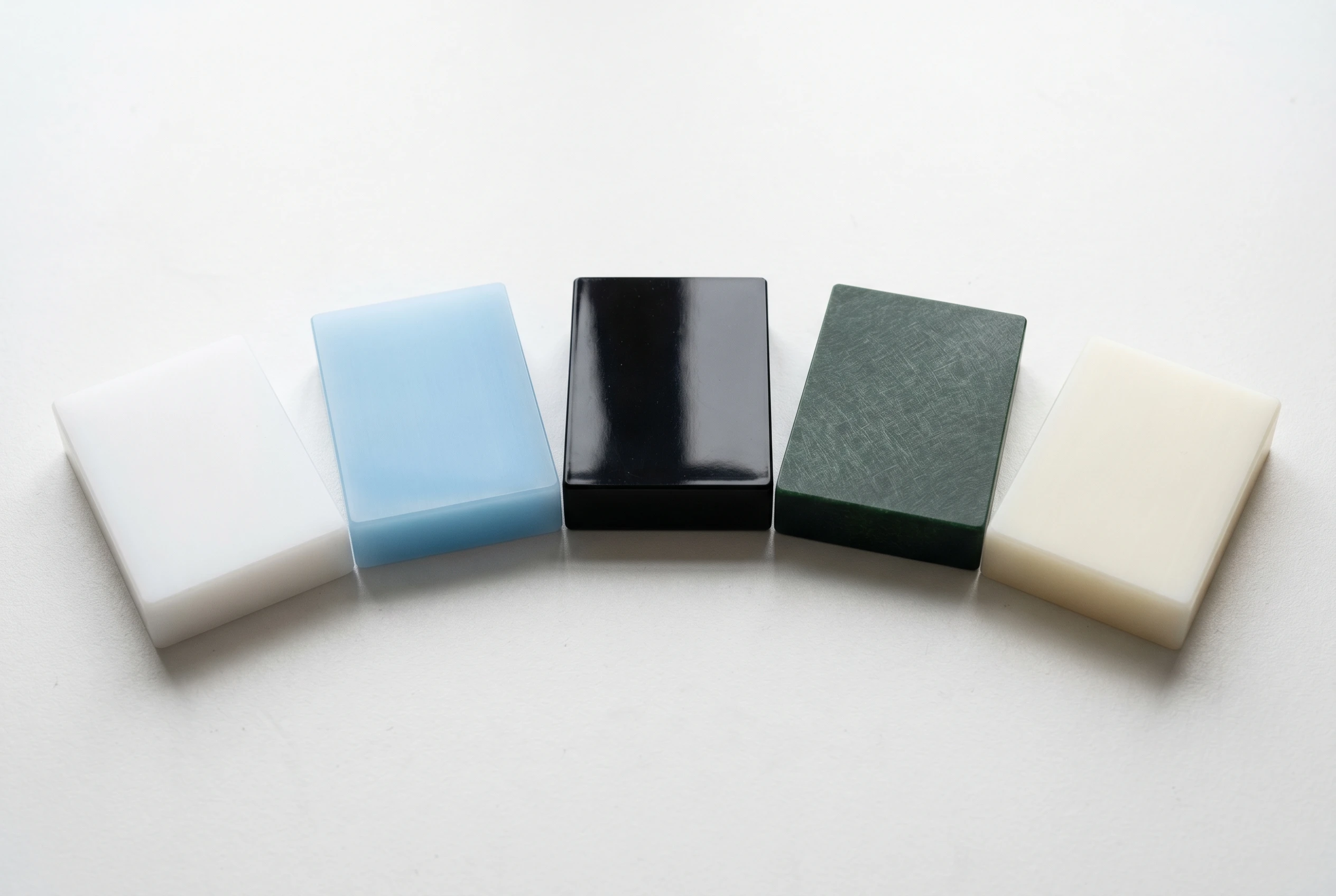 Five plastic material sample blocks: HDPE, PP, ABS, PA6-GF30 and UHMWPE for pallet insert production