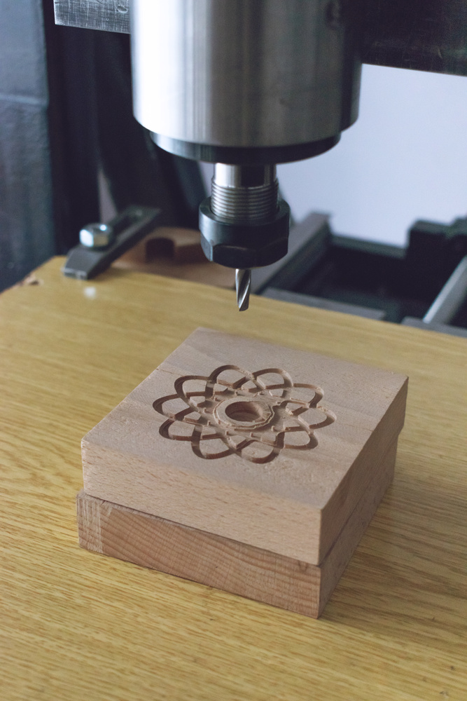 CNC Wood Router Carving Intricate Pattern on Wood Block